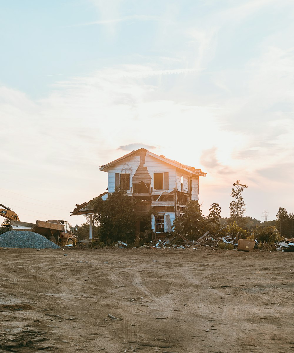 a large house sitting on top of a dirt field