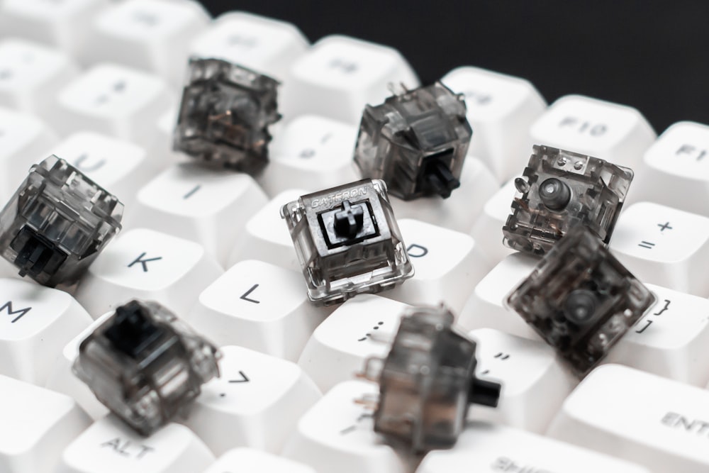 a close up of a keyboard with a bunch of small objects on it