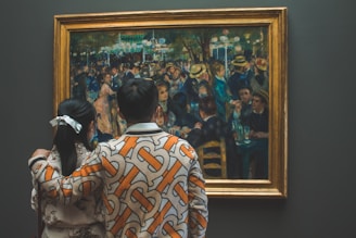 a woman looking at a painting in a museum