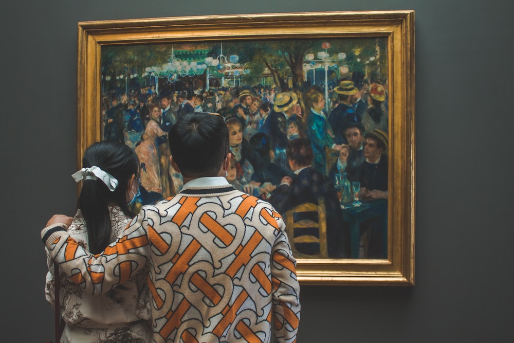 a woman looking at a painting in a museum