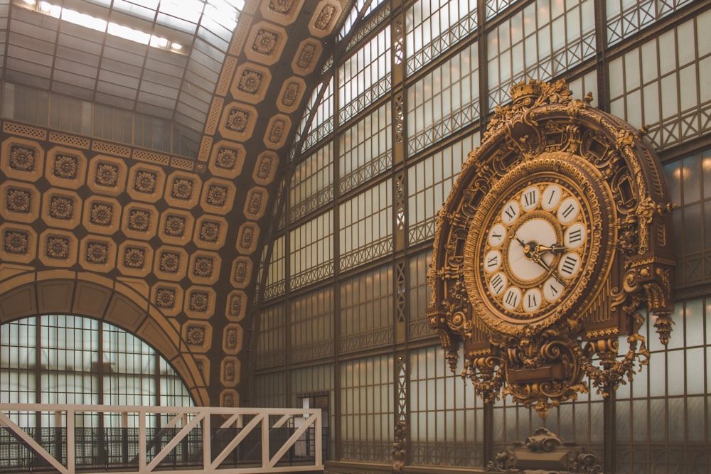 a large clock hanging from the side of a building