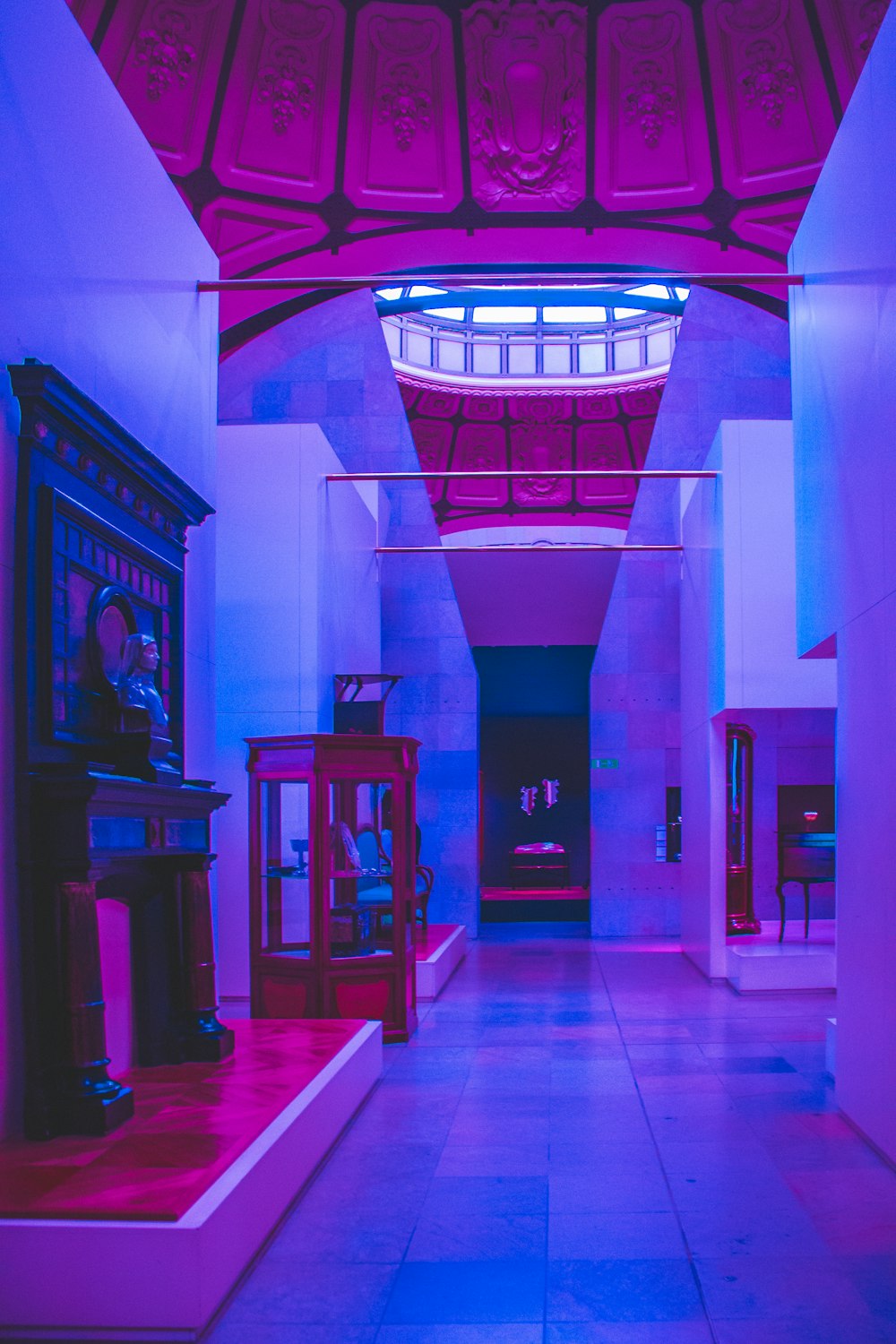 a long hallway with a clock and other items on display