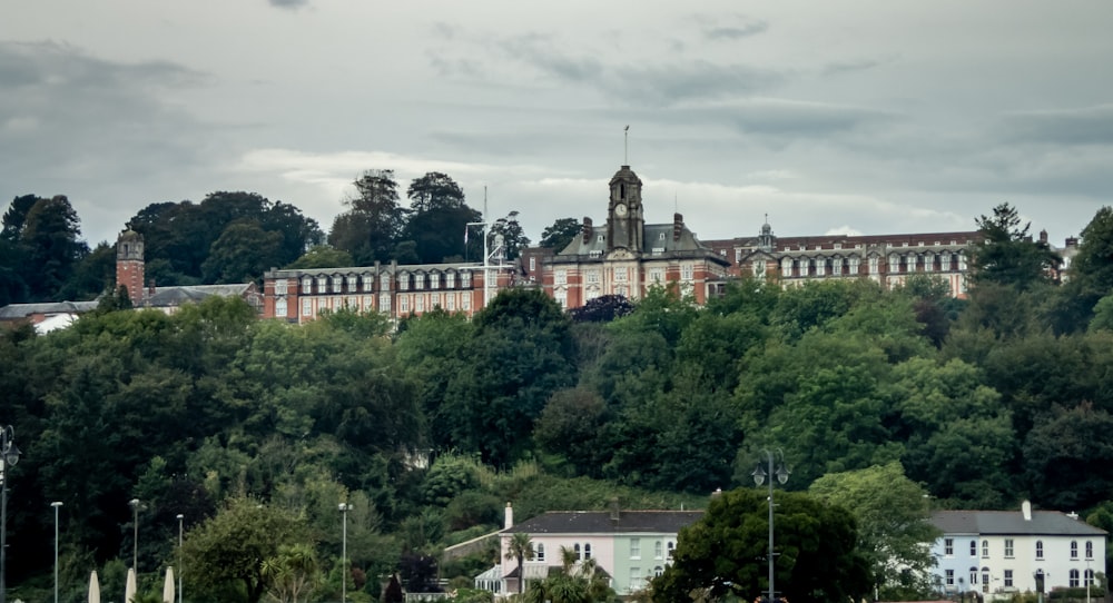 a large building sitting on top of a lush green hillside