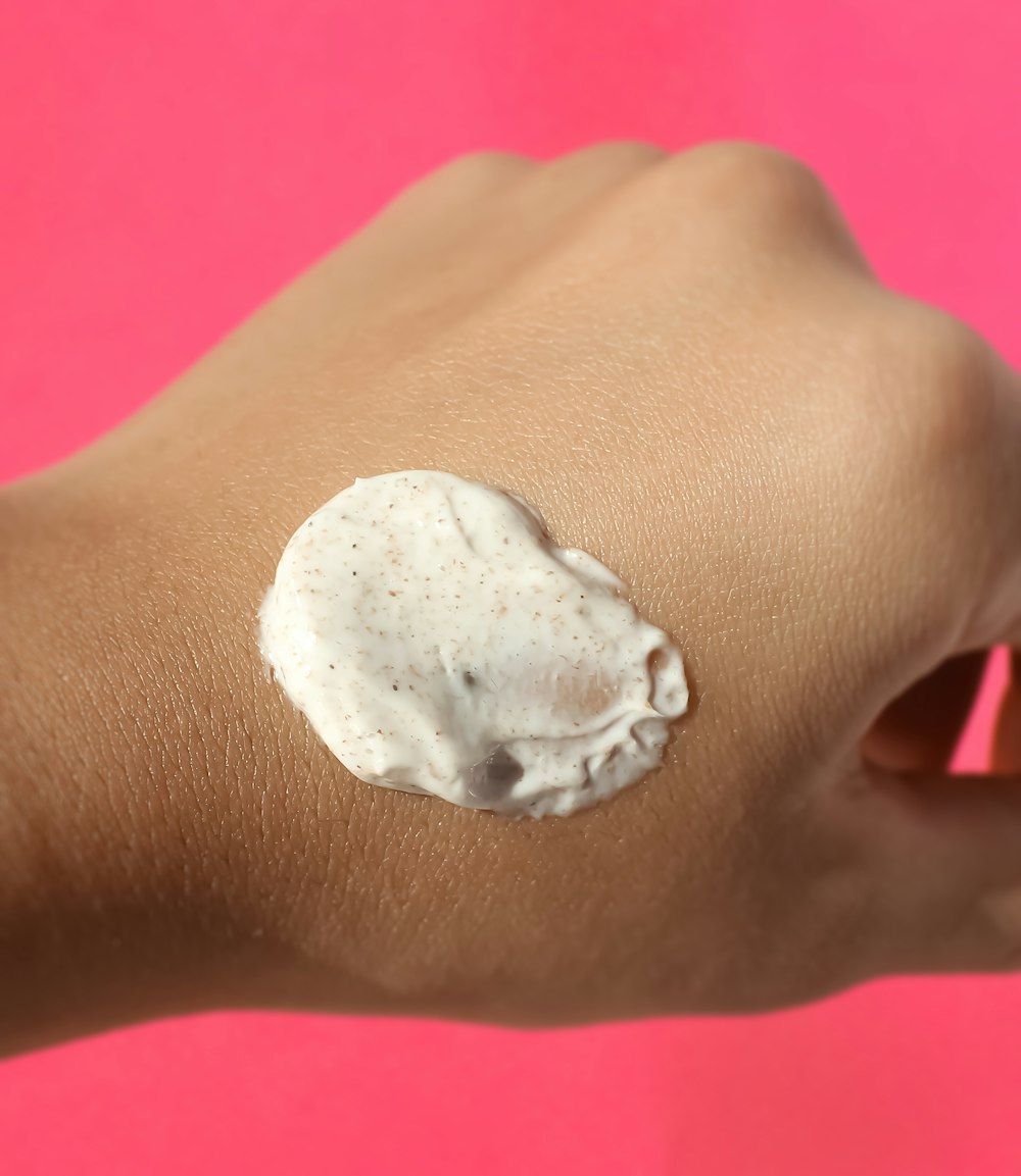 a woman's arm with a cream on it