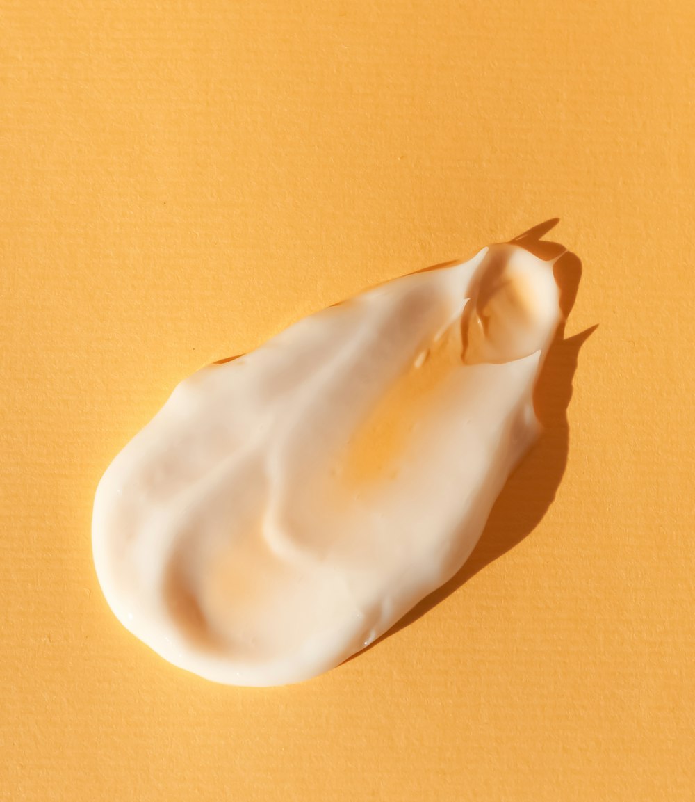 a close up of a white substance on a yellow surface