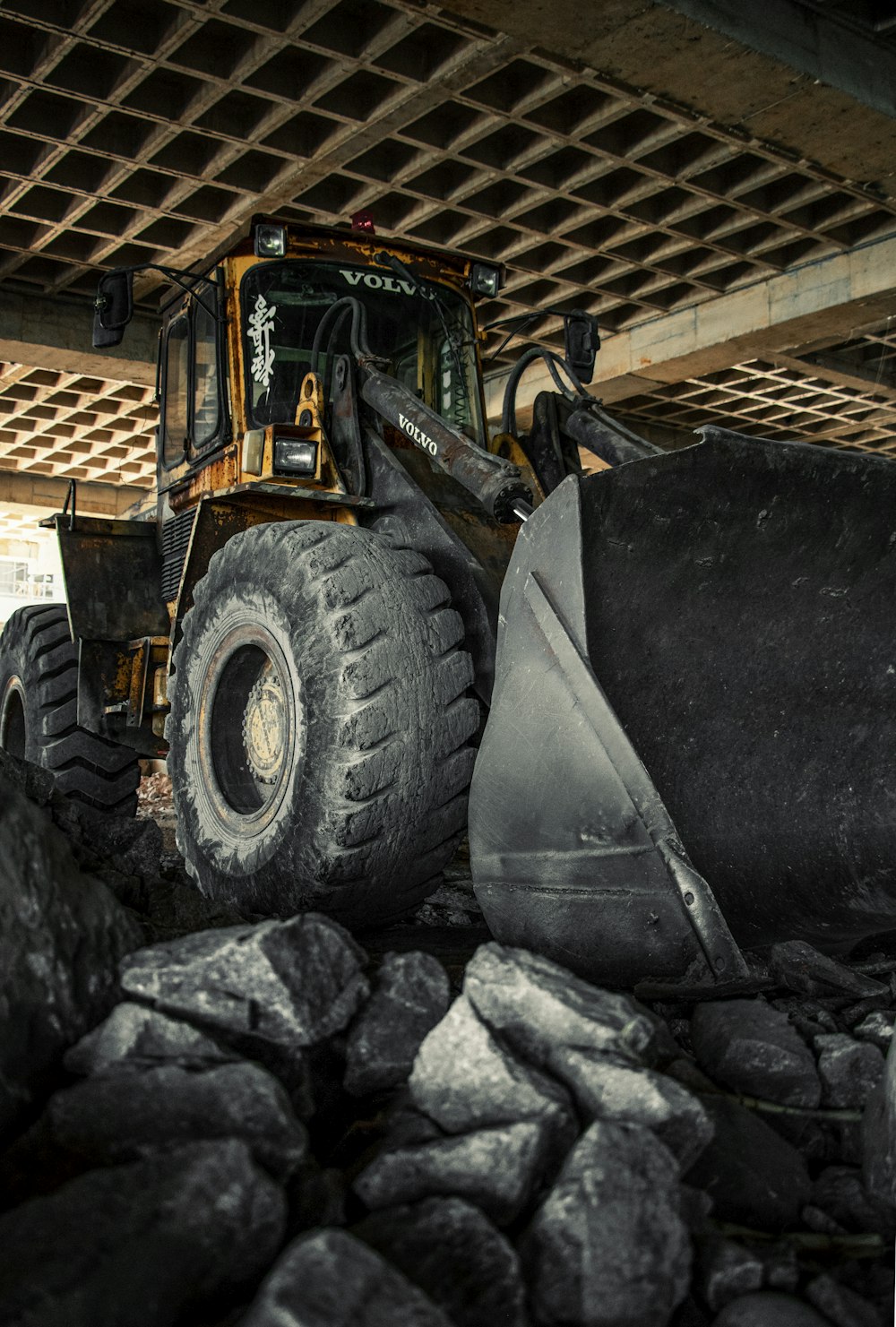 a bulldozer digging through a pile of rocks