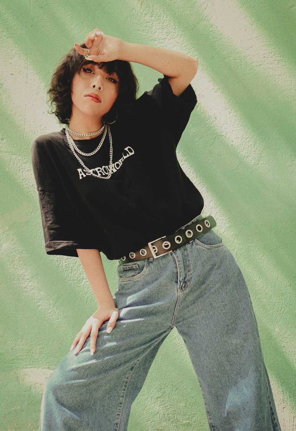 a woman posing for a picture with her hands on her head