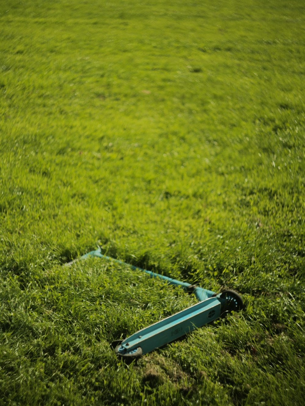 a broken fire hydrant in the middle of a grassy field