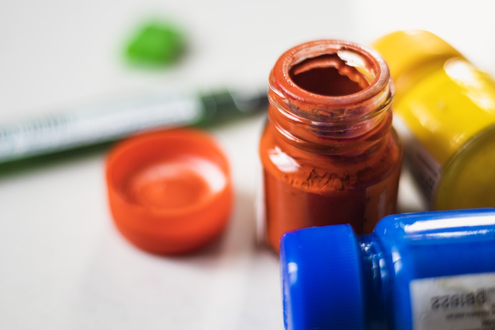 a close up of a bottle of paint and a marker