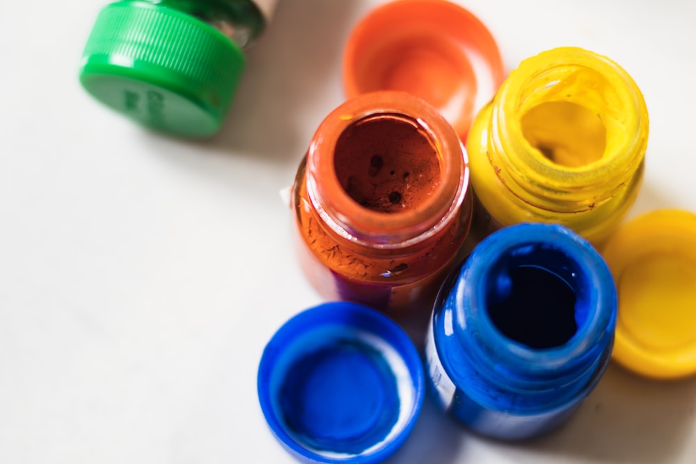 a group of different colored paints sitting on top of a table