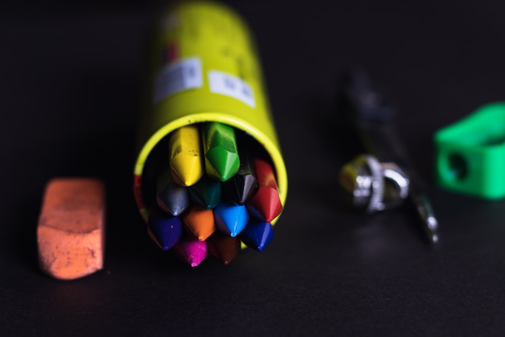a group of crayons sitting next to a pair of scissors