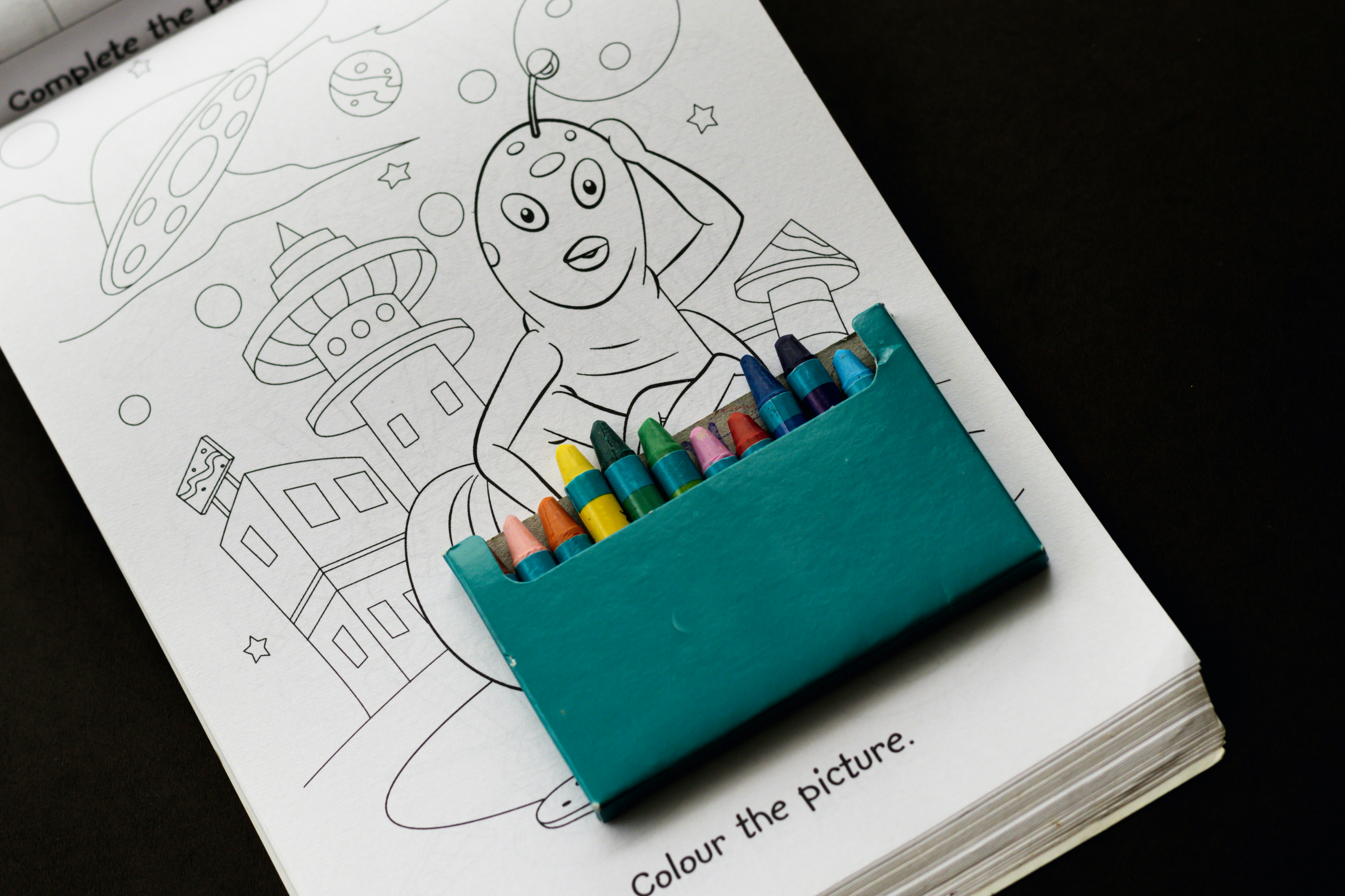 a pencil holder with colored crayons in it