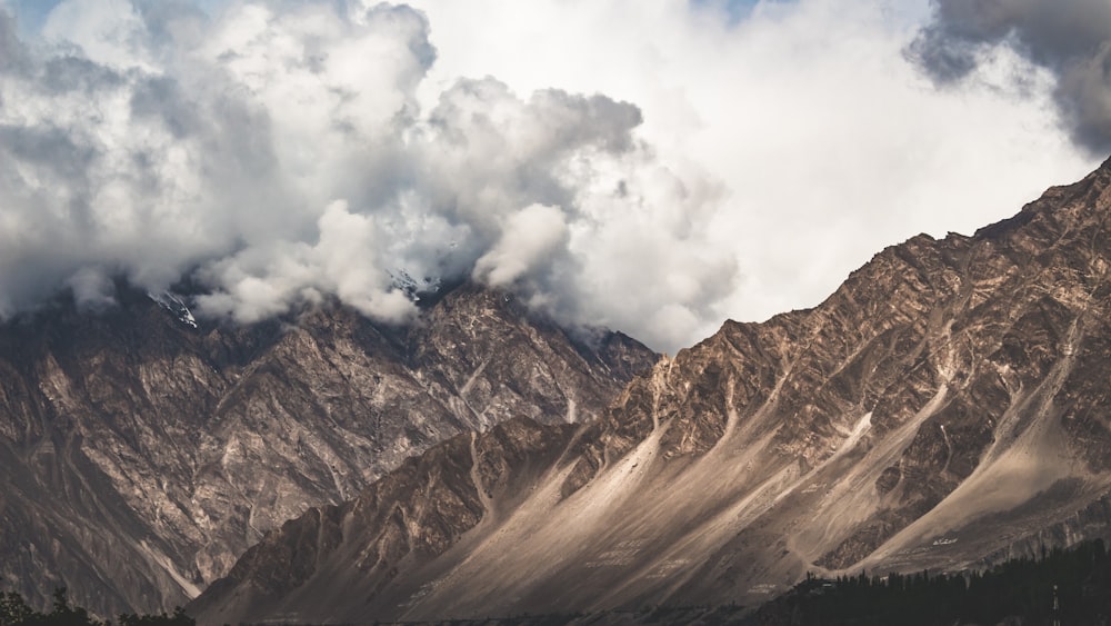 a view of a mountain range with clouds in the sky