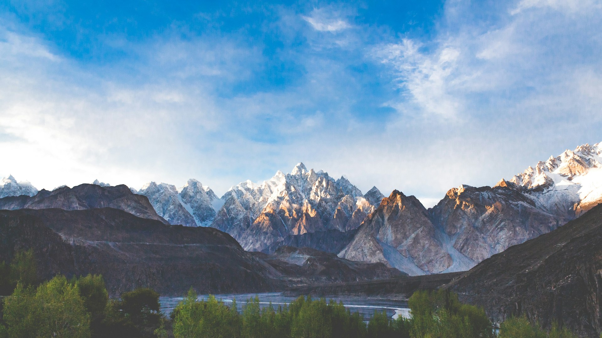 a view of a mountain range with a lake in the foreground