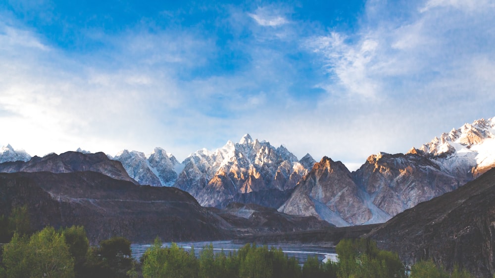 a view of a mountain range with a lake in the foreground