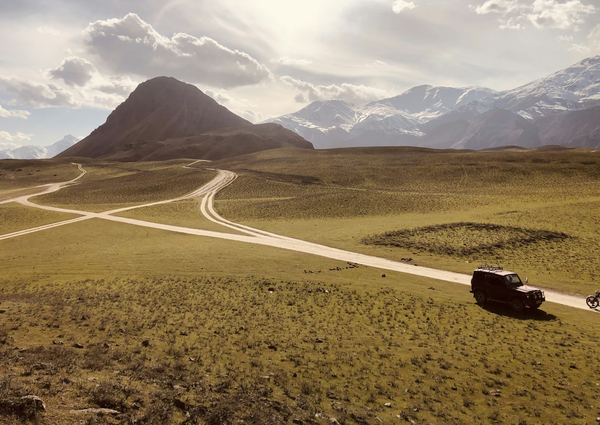 woman wearing yellow long-sleeved dress under white clouds and blue sky during daytime