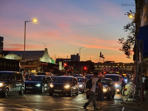 A vibrant street scene bursting with color and movement during golden hour.