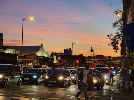 An urban scene showcasing a bustling city street at sunset with vibrant colors.