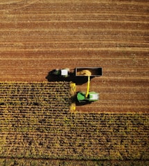 an aerial view of a farmer's tractor in a field