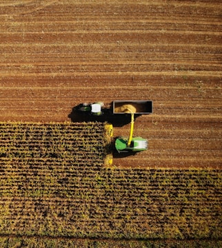 an aerial view of a farmer's tractor in a field