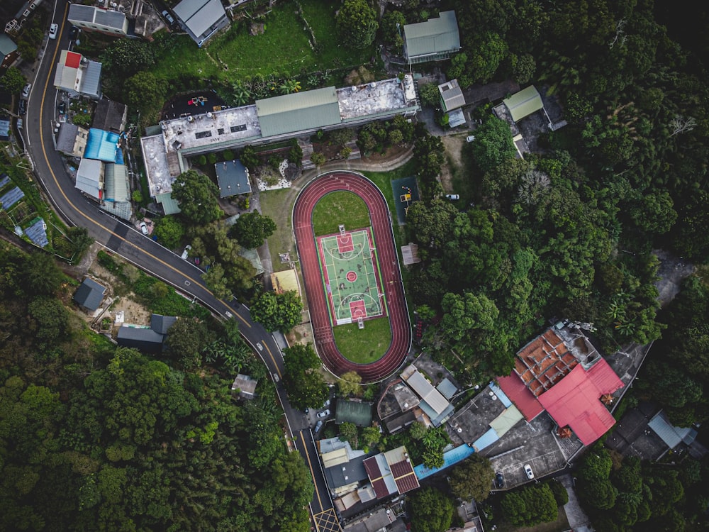 an aerial view of a tennis court surrounded by trees