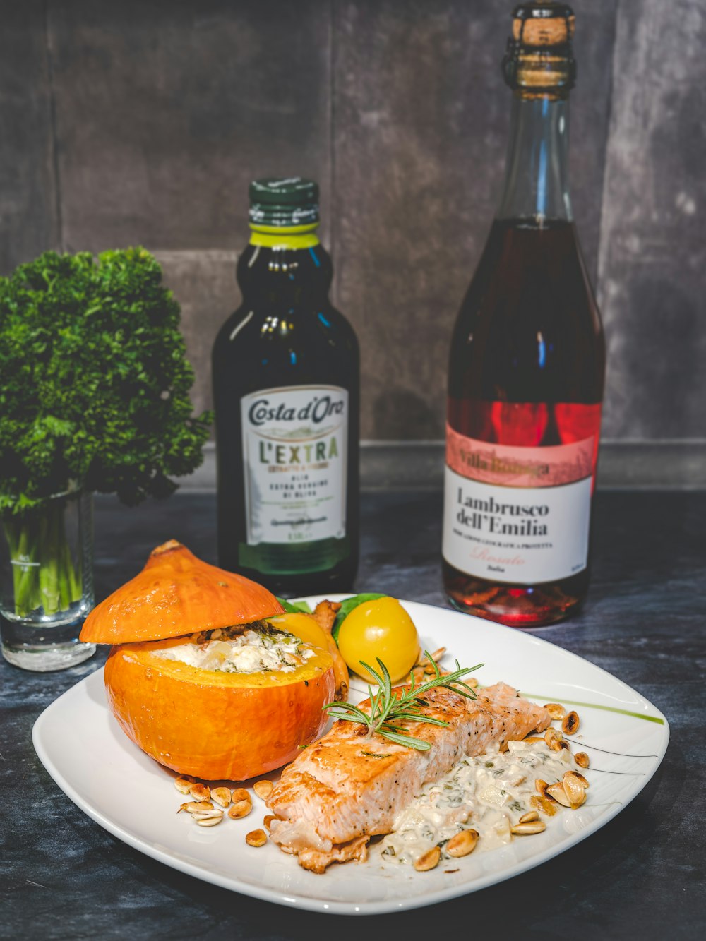 a white plate topped with fish next to bottles of alcohol