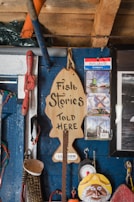 Logo of a small business specializing in fisheries, printed on a wooden plaque.