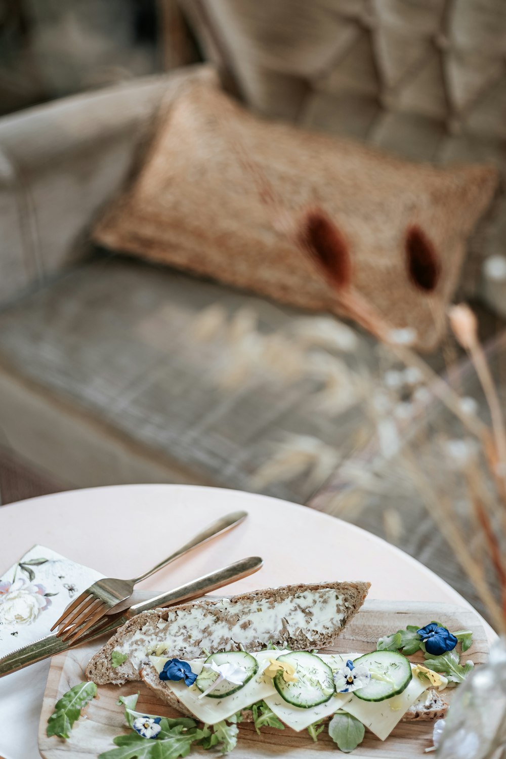 a white plate topped with a piece of bread and cucumbers