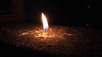 A glowing flame in a dark room, representing the mystical ateş falı session.