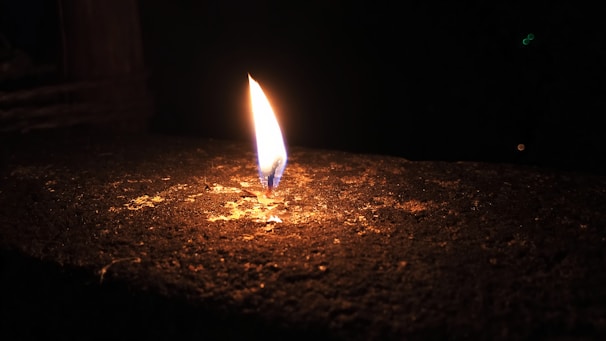 A glowing flame in a dark room, representing the mystical ateş falı session.