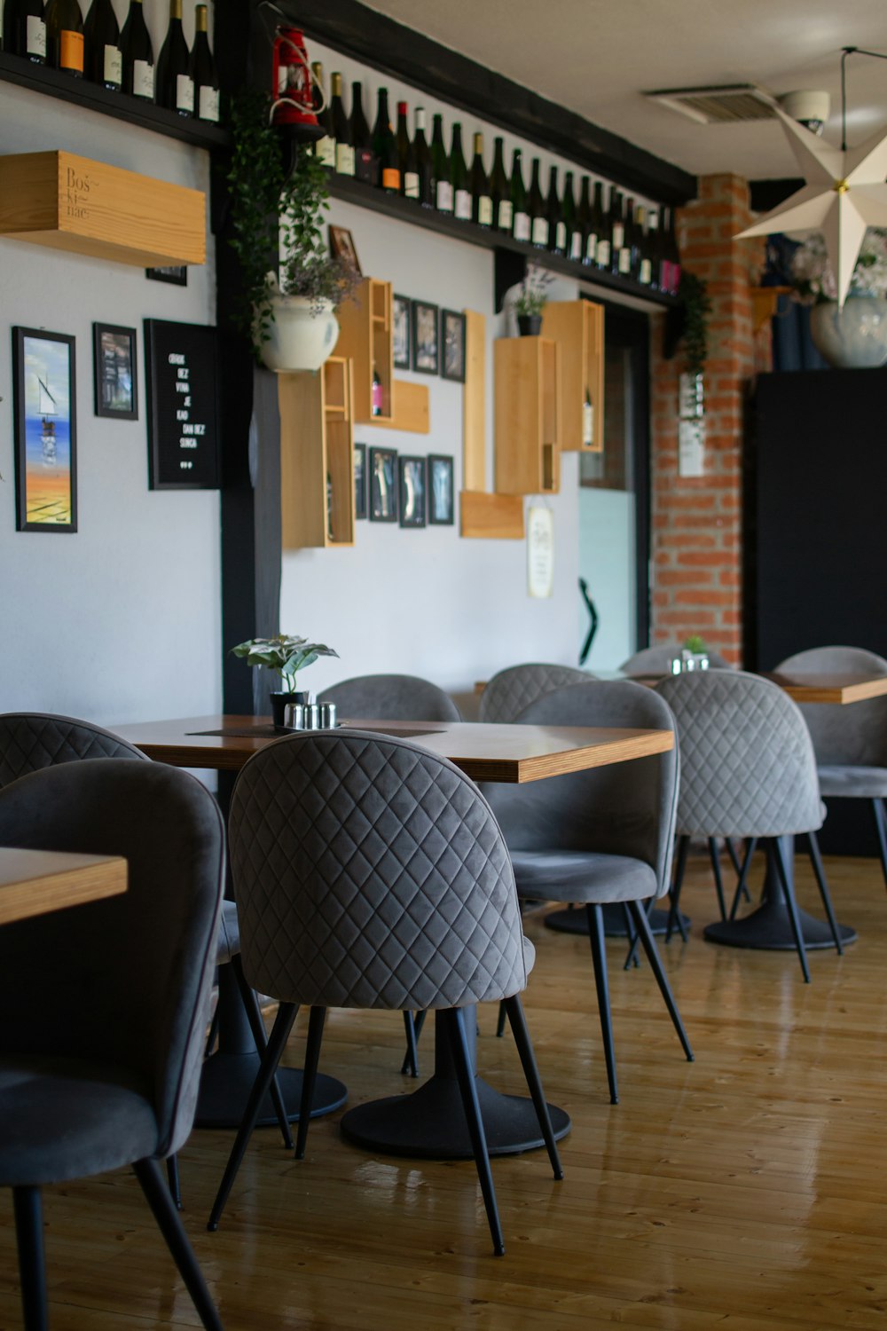 a restaurant with wooden tables and grey chairs