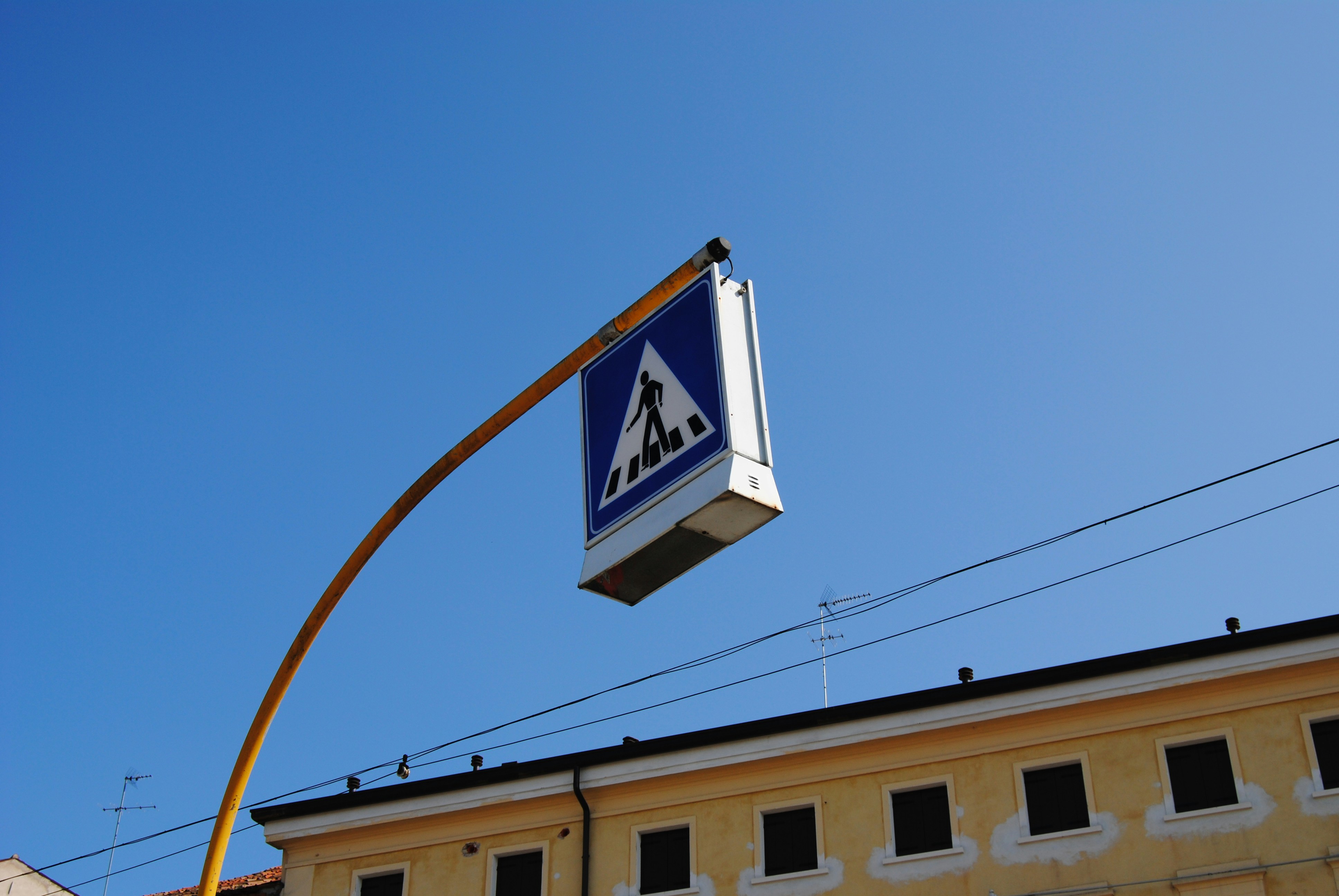 a blue and white sign hanging off the side of a building