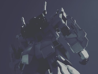 A large robotic figure stands with a powerful presence against a dark background. The robot, featuring angular and mechanical components, appears to be a mech or a futuristic machine designed for combat or heavy-duty tasks. The perspective is from below, emphasizing its size and dominance.