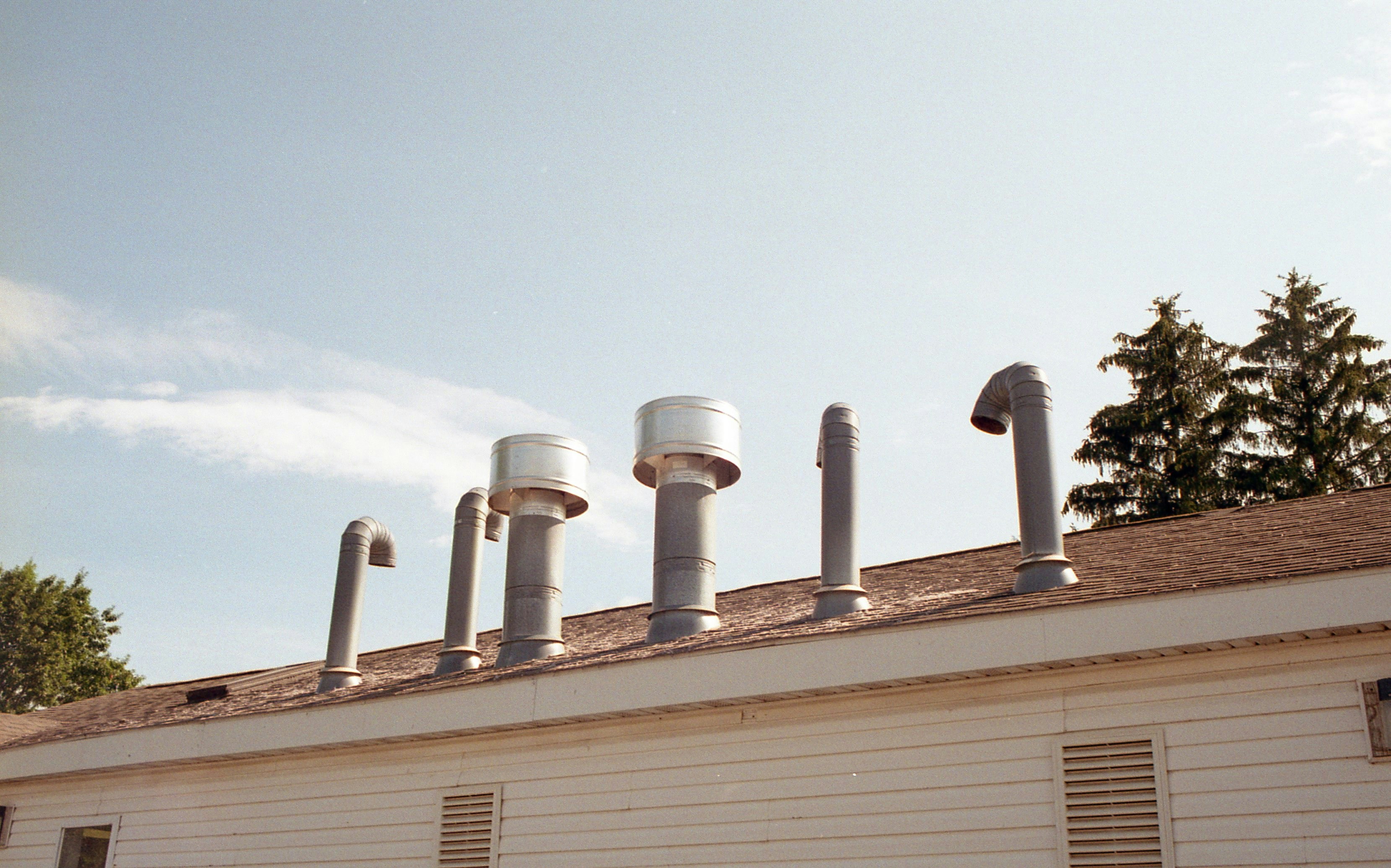 a row of pipes on top of a building