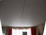 a room with a window and a white ceiling