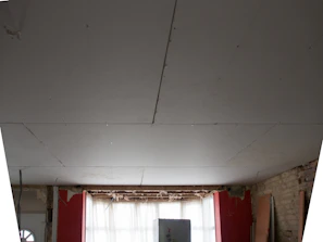 a room with a window and a white ceiling