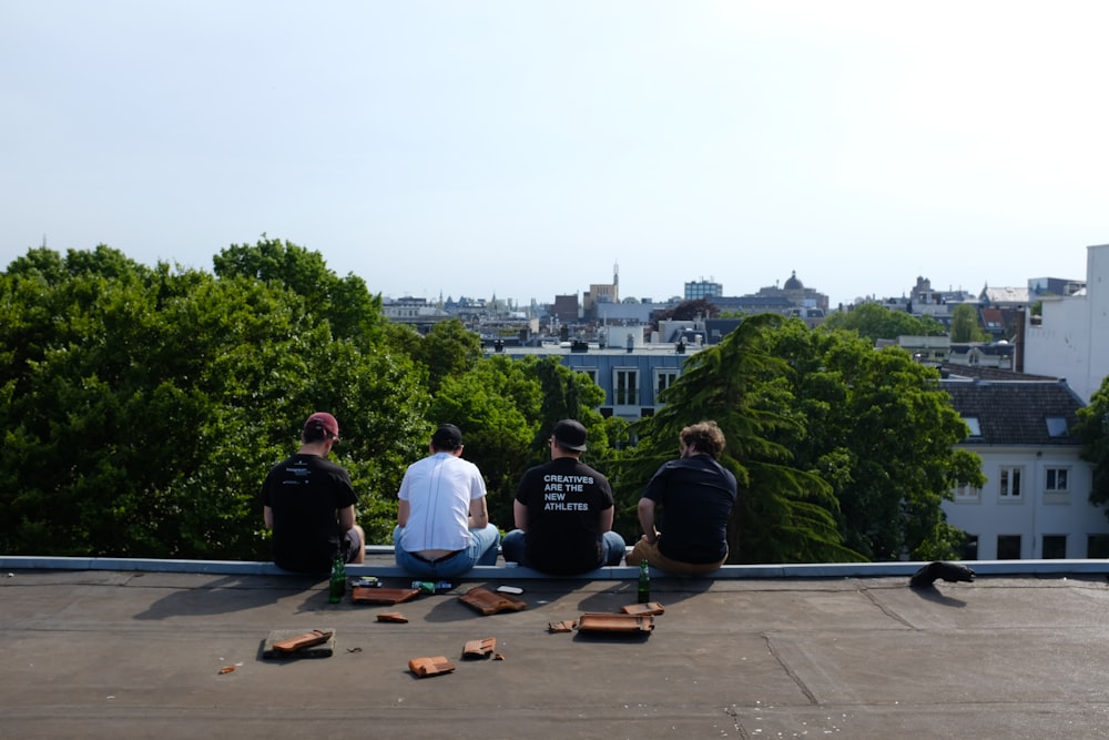 a group of people sitting on top of a roof