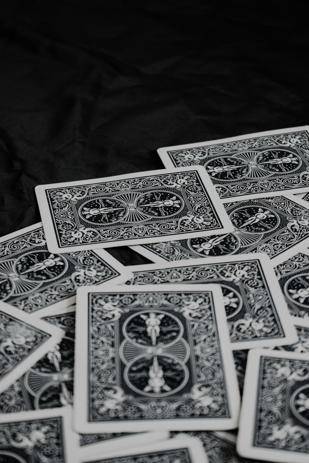 a pile of playing cards sitting on top of a table