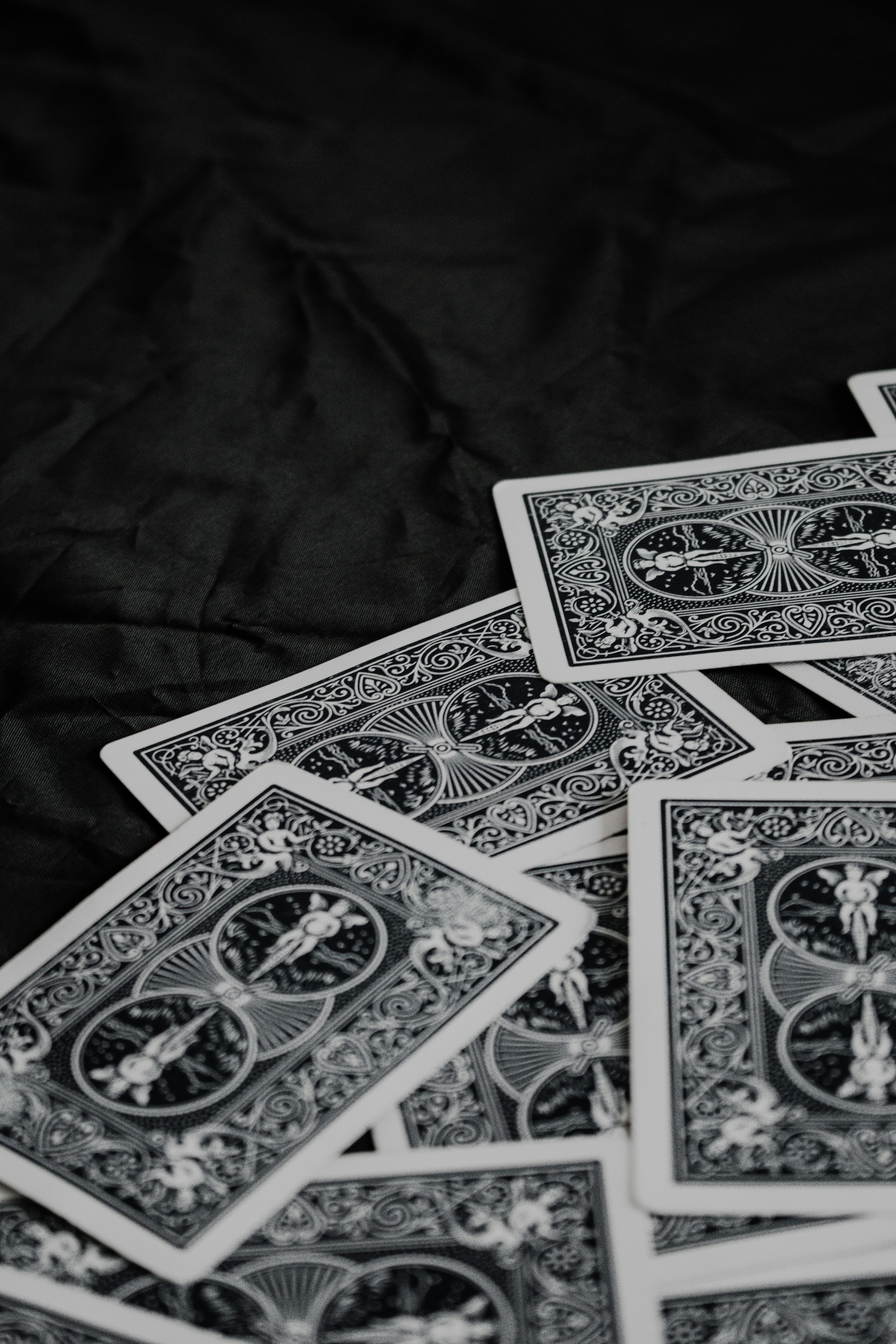 A spread of various 'play shthead' cards laid out on a dark wooden surface, each card showing different vibrant designs and power icons.
