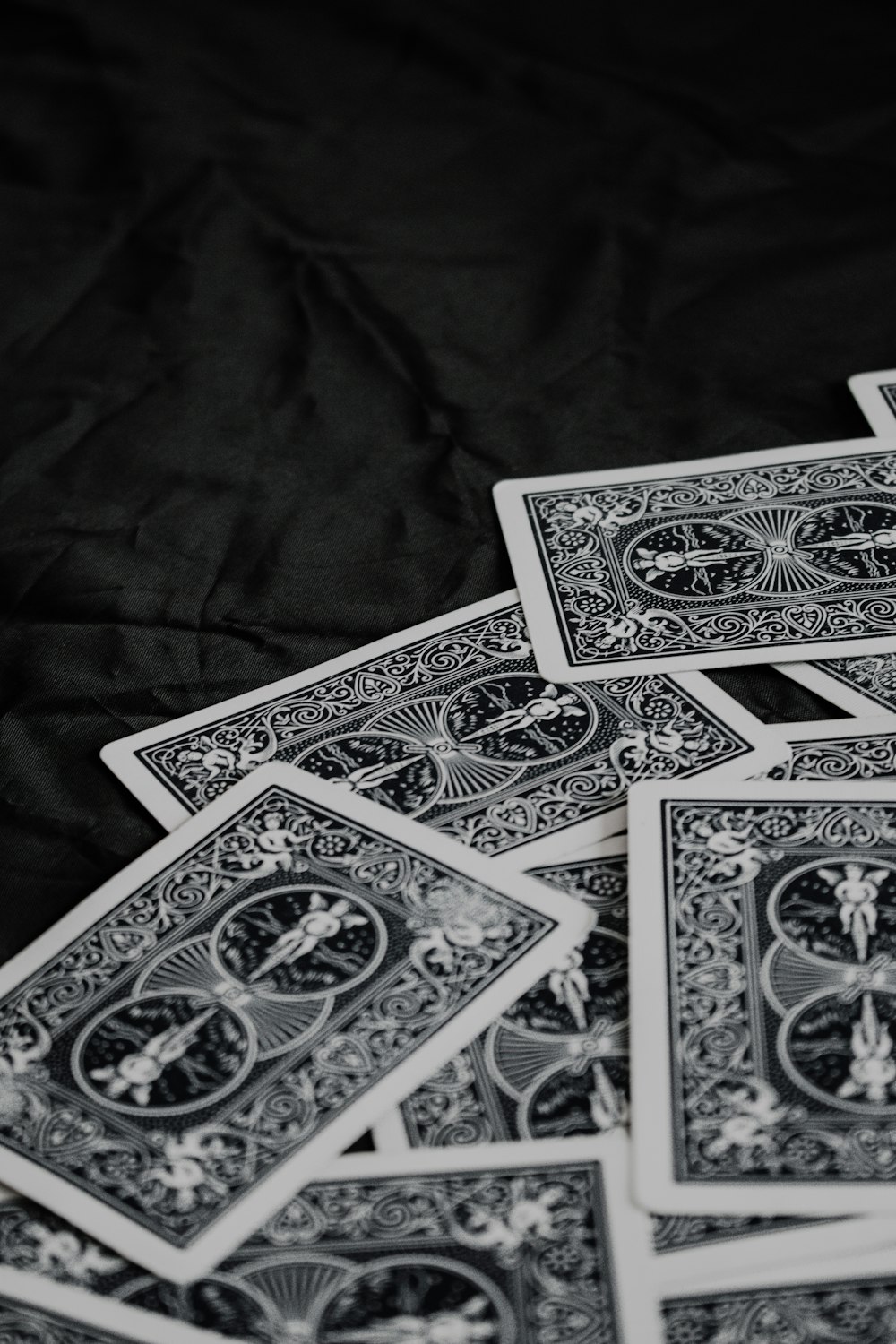 a pile of playing cards sitting on top of a table