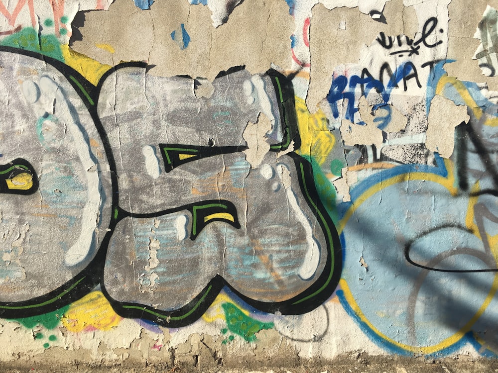 a wall covered in graffiti with the number fifty painted on it