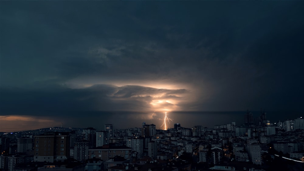 a lightning bolt is seen over a city at night