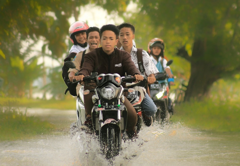 a group of people riding on the back of a motorcycle