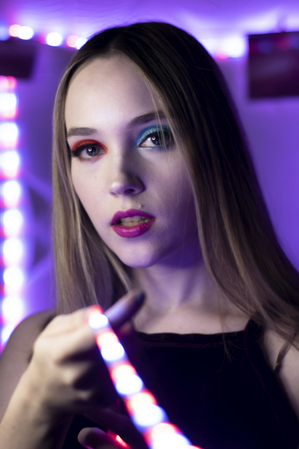 a woman holding a toothbrush in her hand