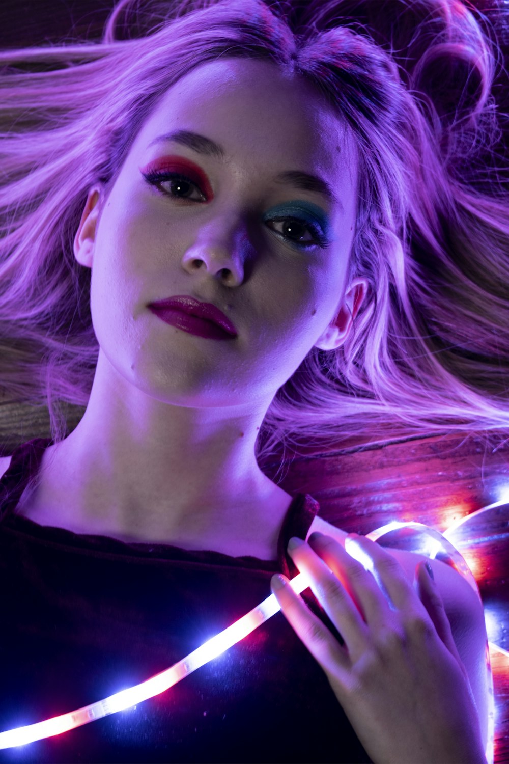 a woman with long blonde hair and bright lights