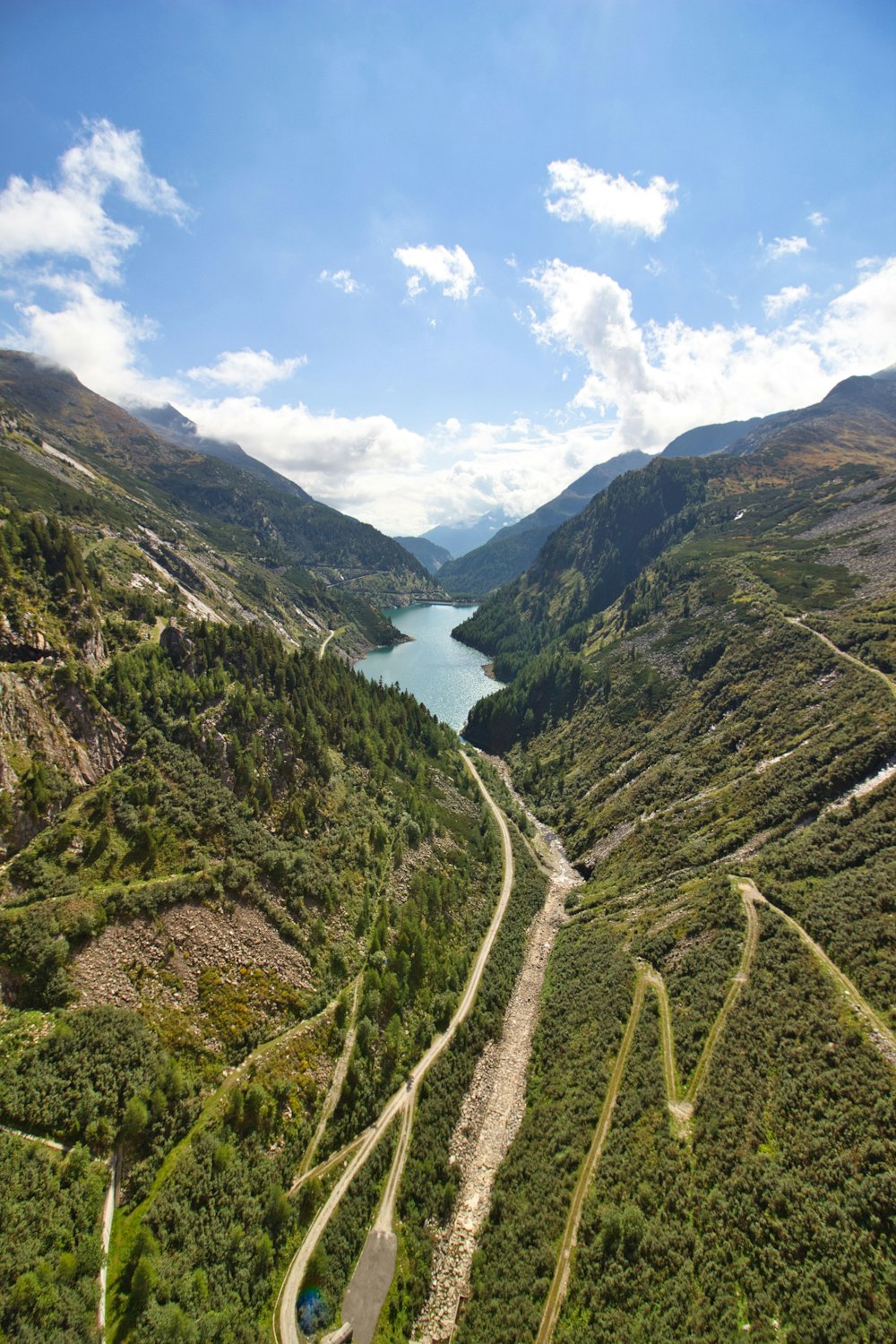 an aerial view of a winding road in the mountains