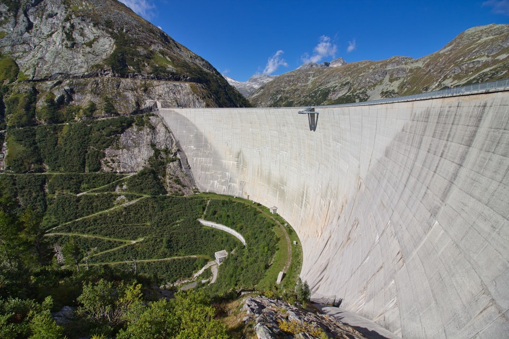 a view of a large dam with mountains in the background