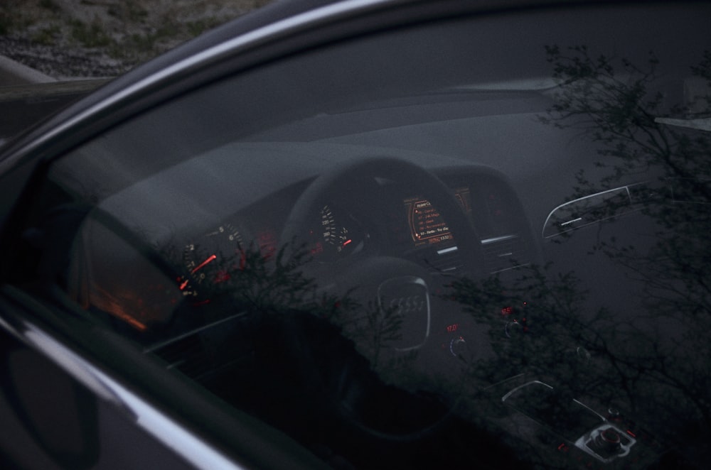 the dashboard of a car with the lights on