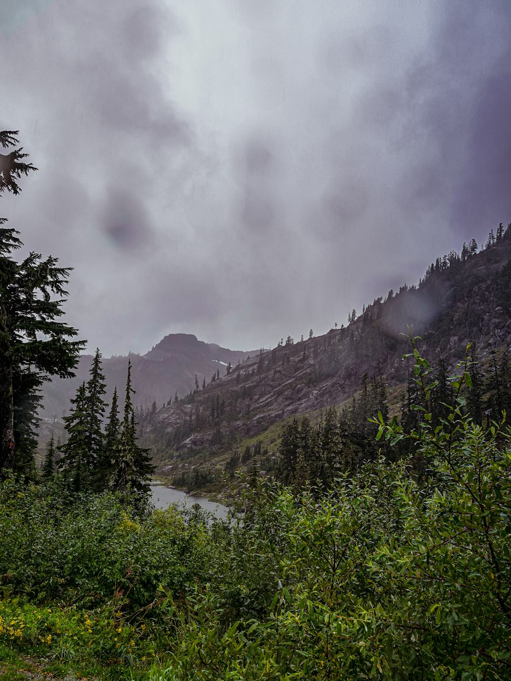 a view of a mountain with a river in the foreground