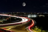 a long exposure photo of a highway at night